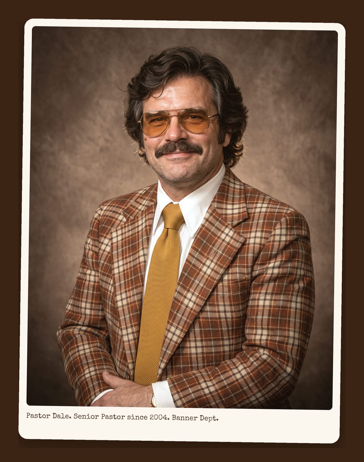 Pastor Dale Honeycutt, hands folded, plaid sport coat and mustard tie, directory portrait.